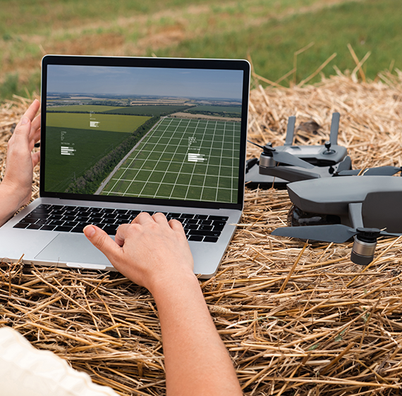 Drone feeding real-time data to a laptop in the field.