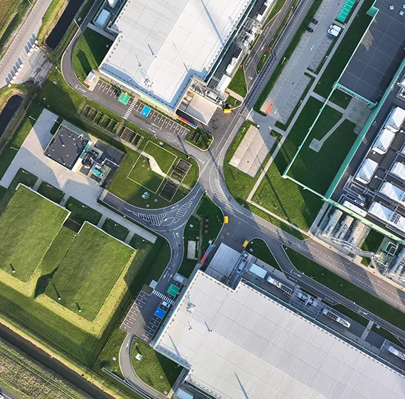 Aerial view of business park with cars and buildings.
