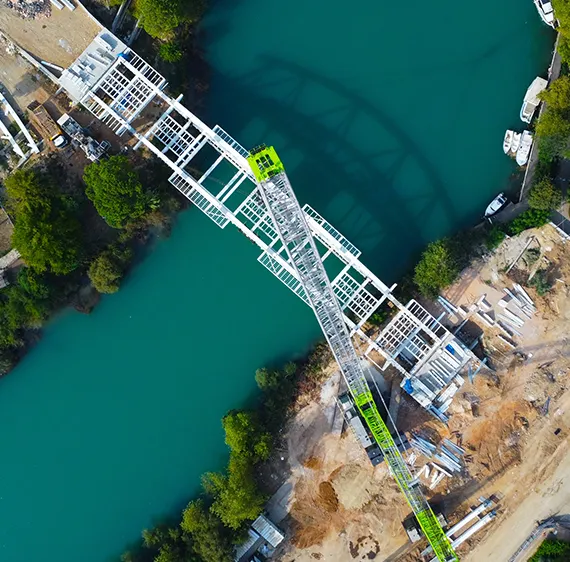 Aerial view of a river with new bridge construction including a crane.