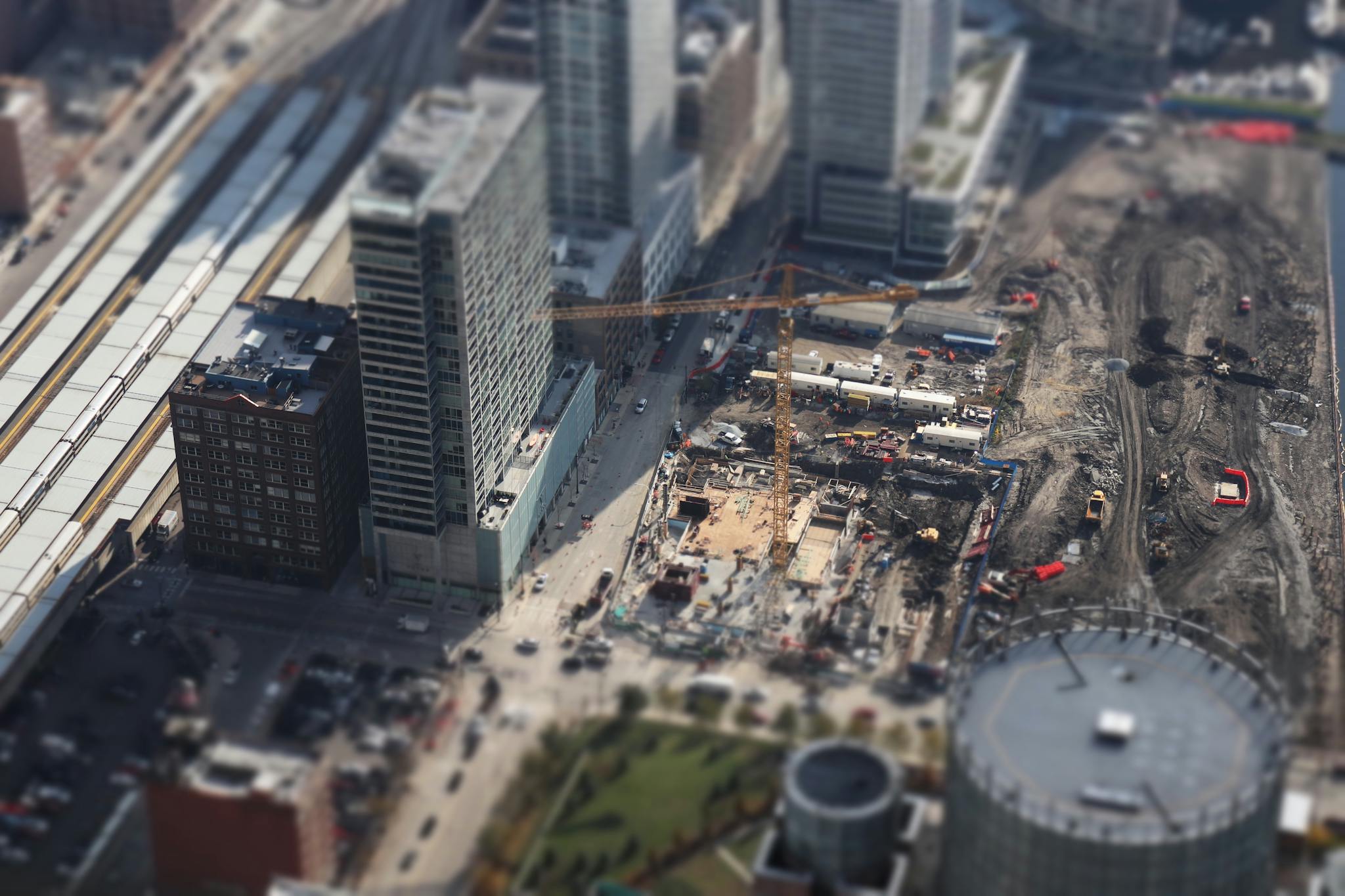 An aerial tilt-shift view of a bustling construction site in downtown Chicago, showcasing urban development.